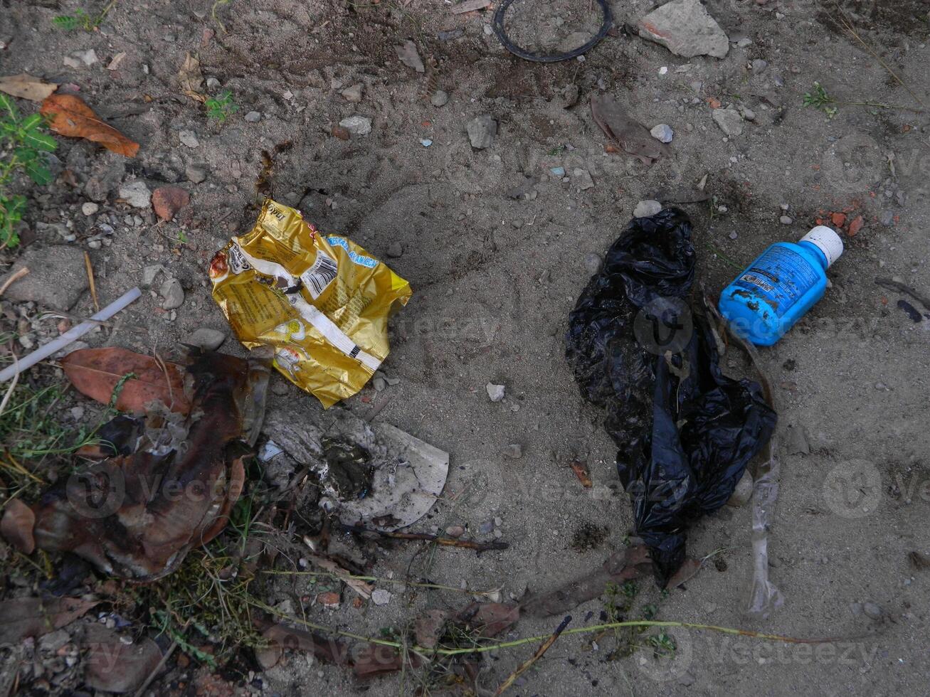 Waste that can damage the environment is often found in urban areas with poor waste management photo