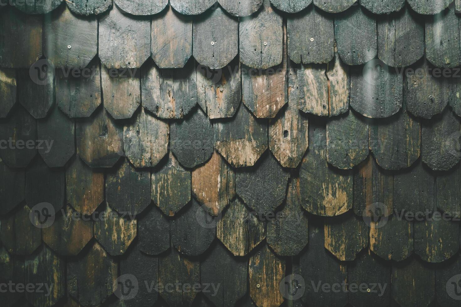 Old wooden roof tiles background. Old wooden shingles. photo