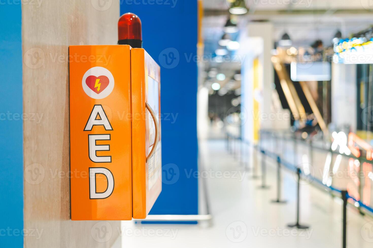 Automated External Defibrillator box AED machine with instructions on the wall in shopping mall. photo