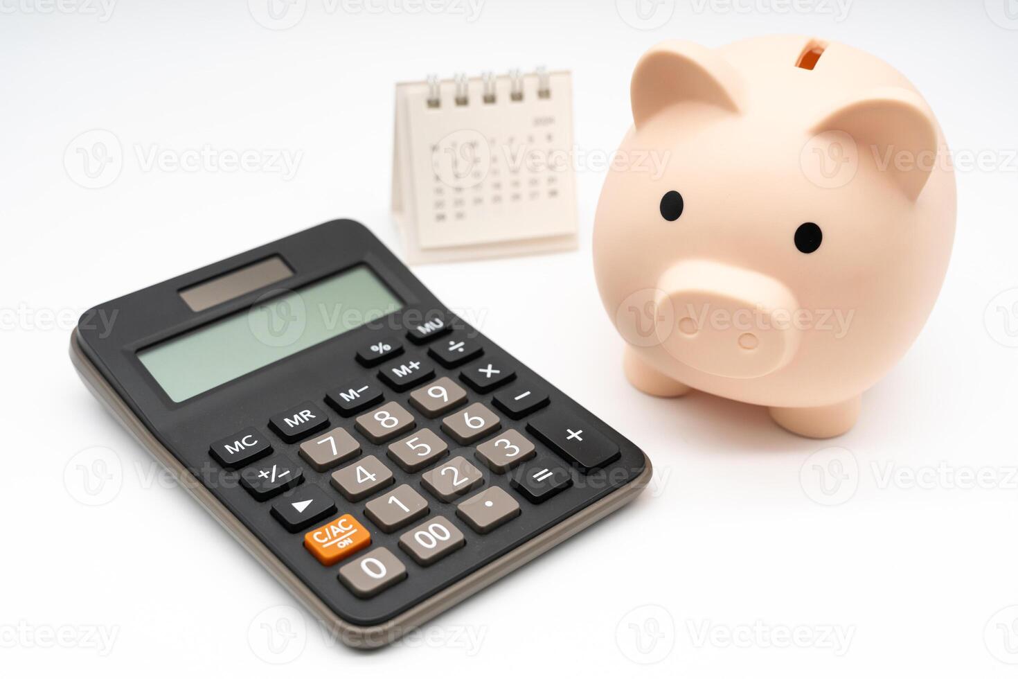 Piggy bank with calculator and calendar on white background, financial goal, money saving concept with copy space. Budget planning concept. photo