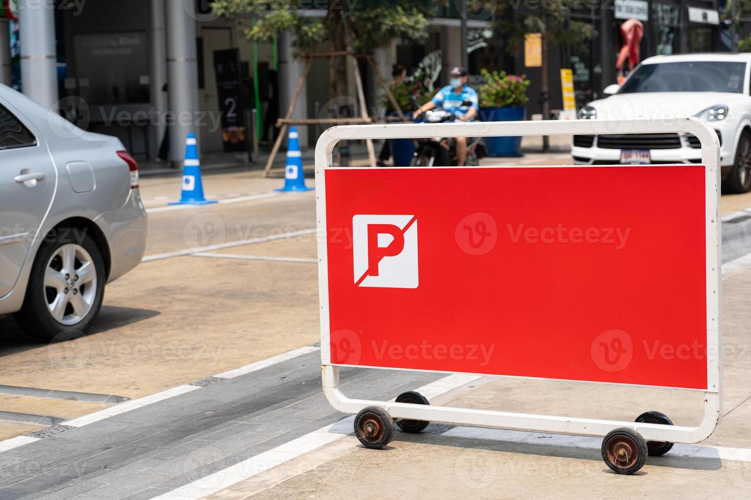 Red no parking sign on a metal fence with copy space. photo