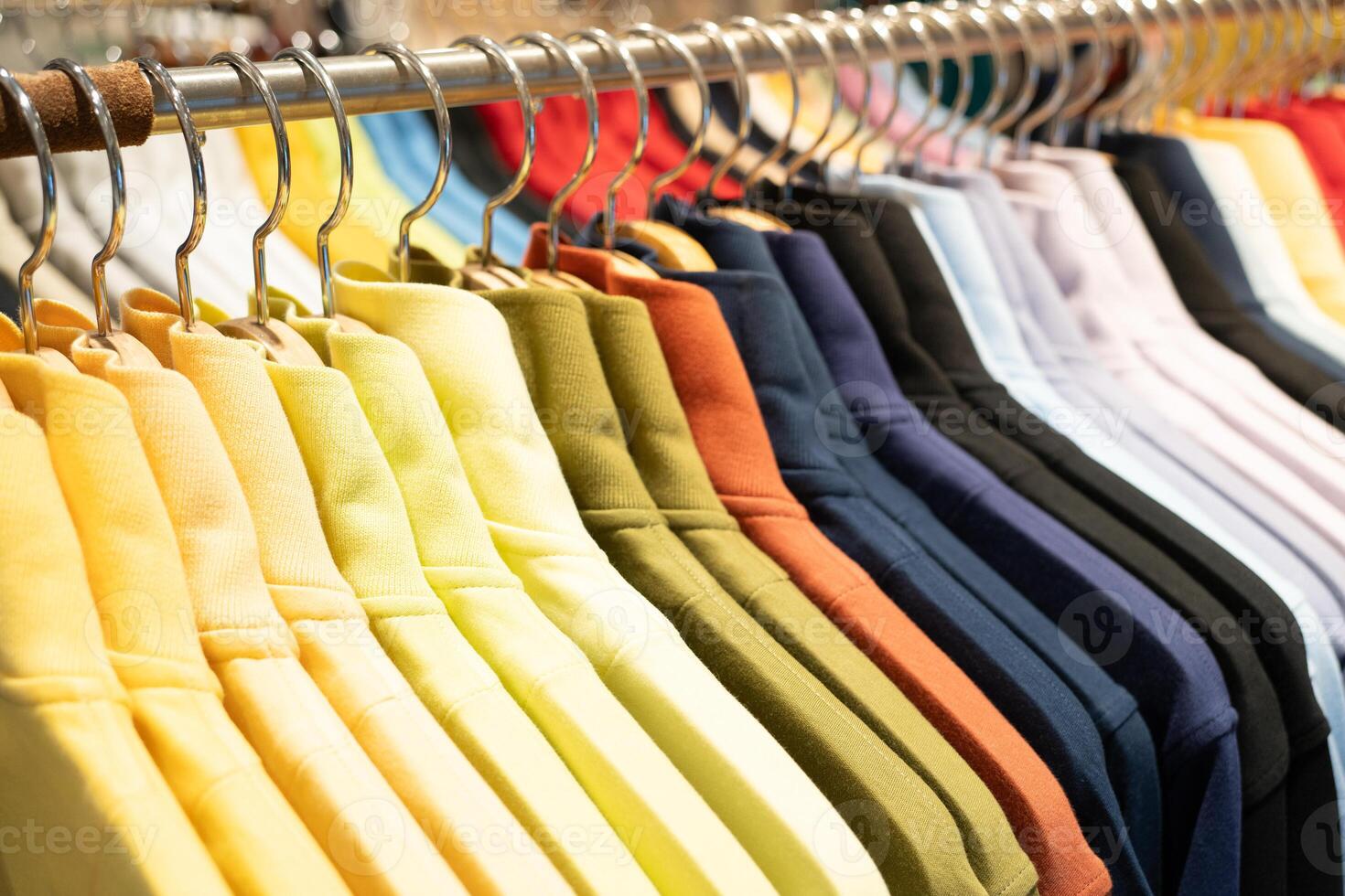 Selective focus, Fashion , clothes concept ,Clothes or pants many colors hang on a shelf in a designer clothes store. Clothing hanging on a clothing rack in a store. photo