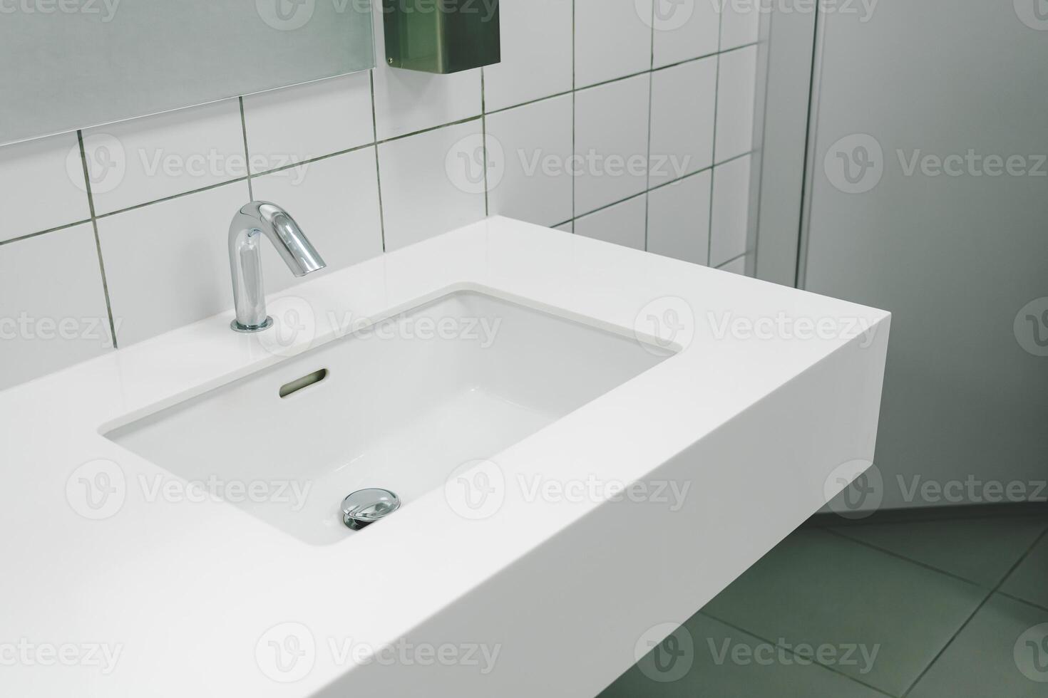 Bathroom interior with sink and faucet. Modern washbasin with chrome faucet photo