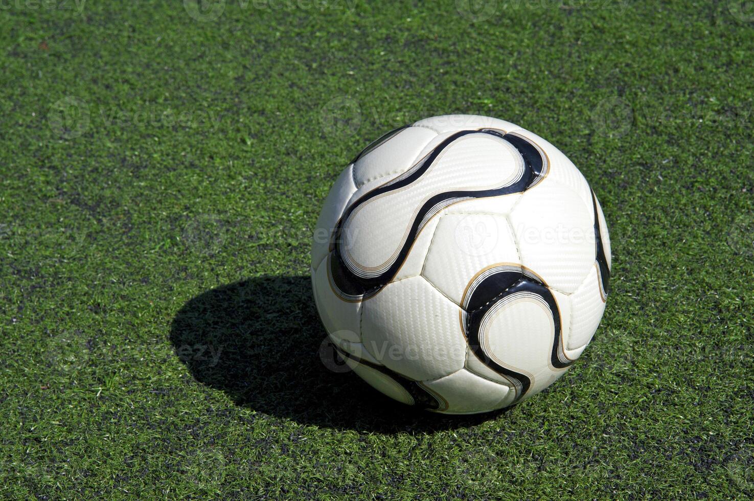 football or soccer ball on the grass photo