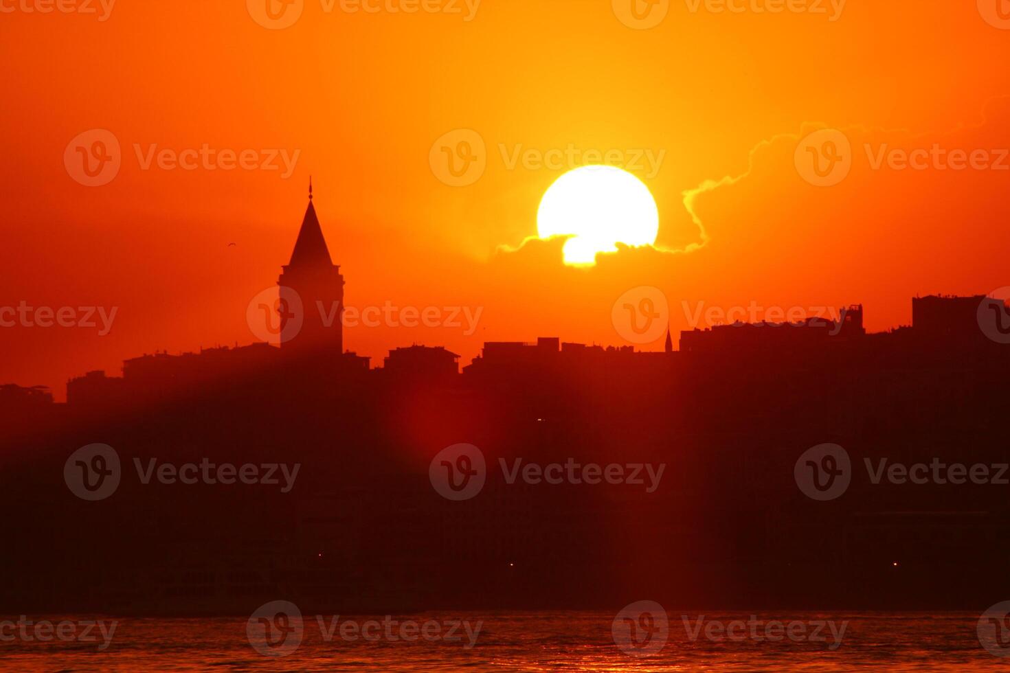 Galata Tower view at sunset with sun behind the clouds photo