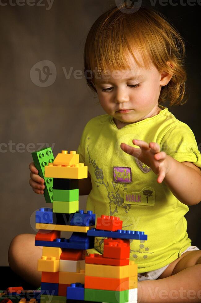 Small girl plays with the designer photo