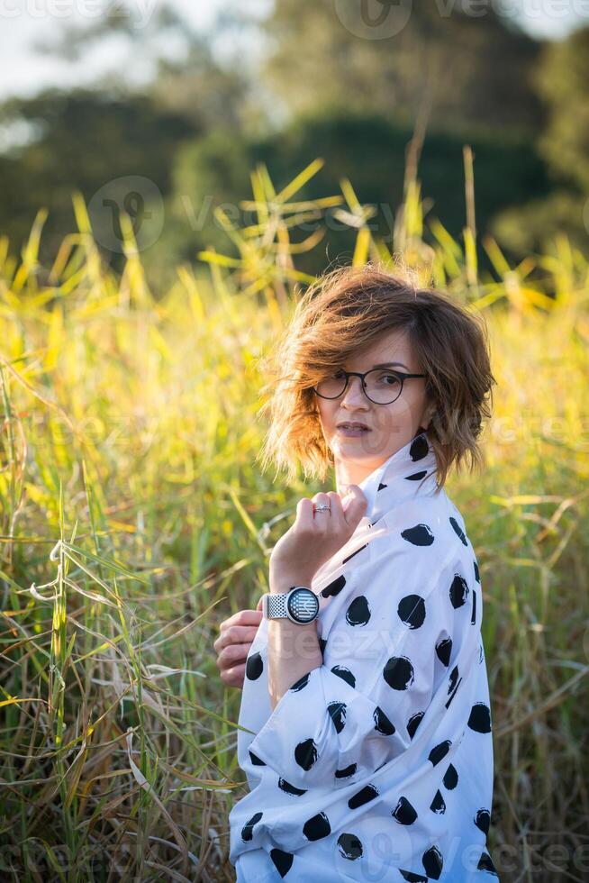 Fashion shot of a beautiful boho style girl on nature background. Boho, hippie. photo