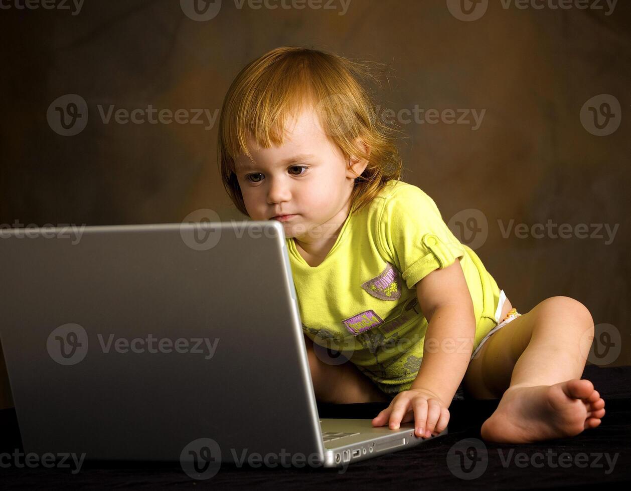 Small girl works with the computer photo