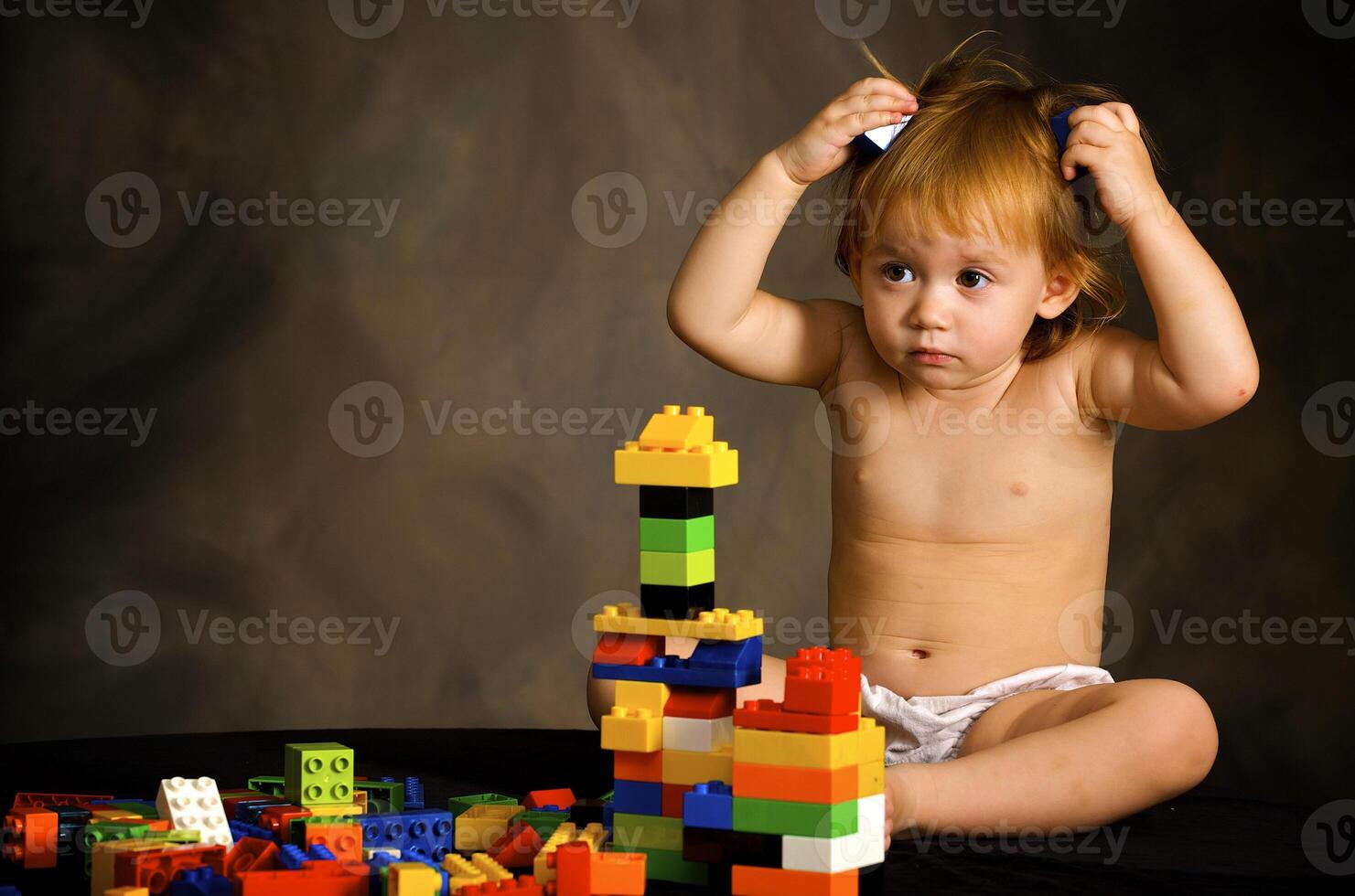 Small girl plays with the designer photo