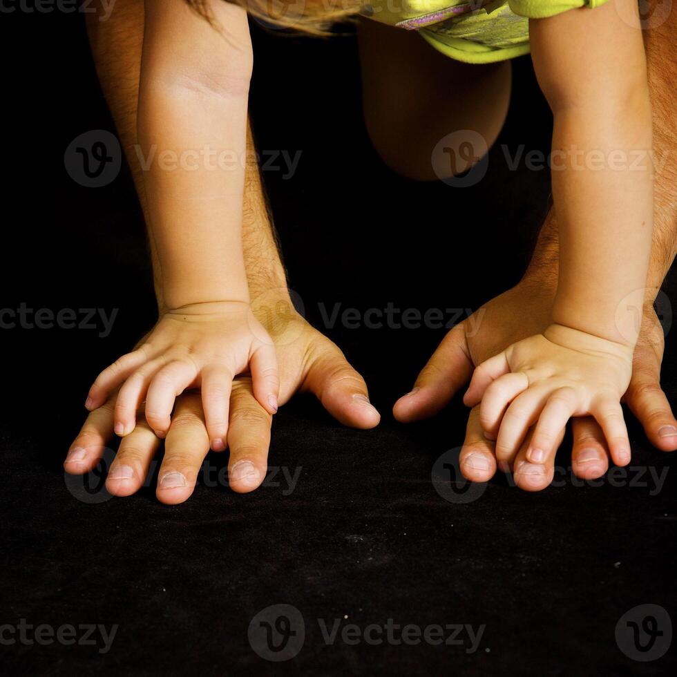 Daughter holds the hand of the father photo