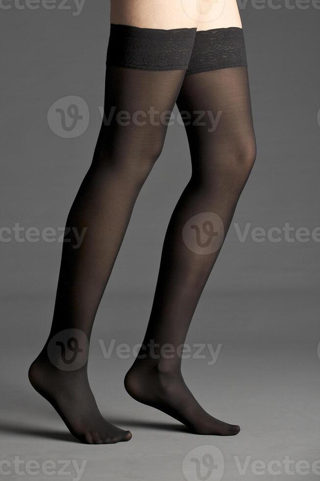 Beautiful woman legs on dark background photo
