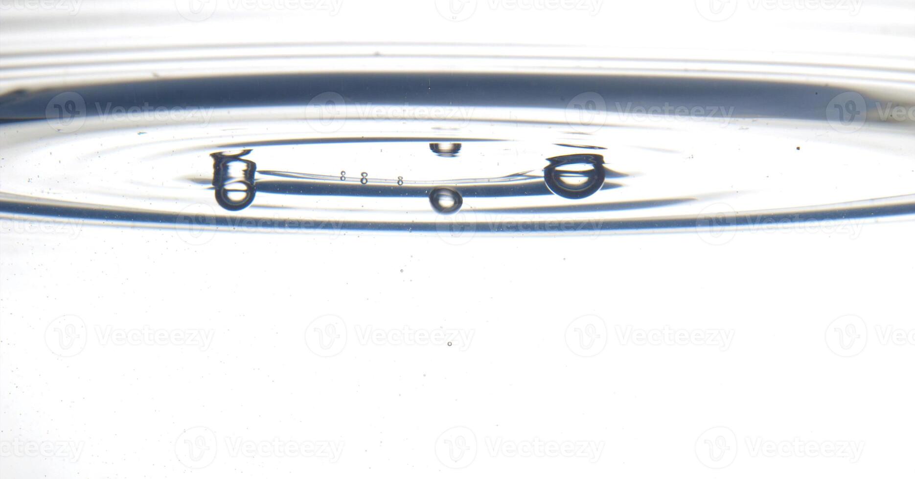 The round transparent drop of water, falls downwards photo