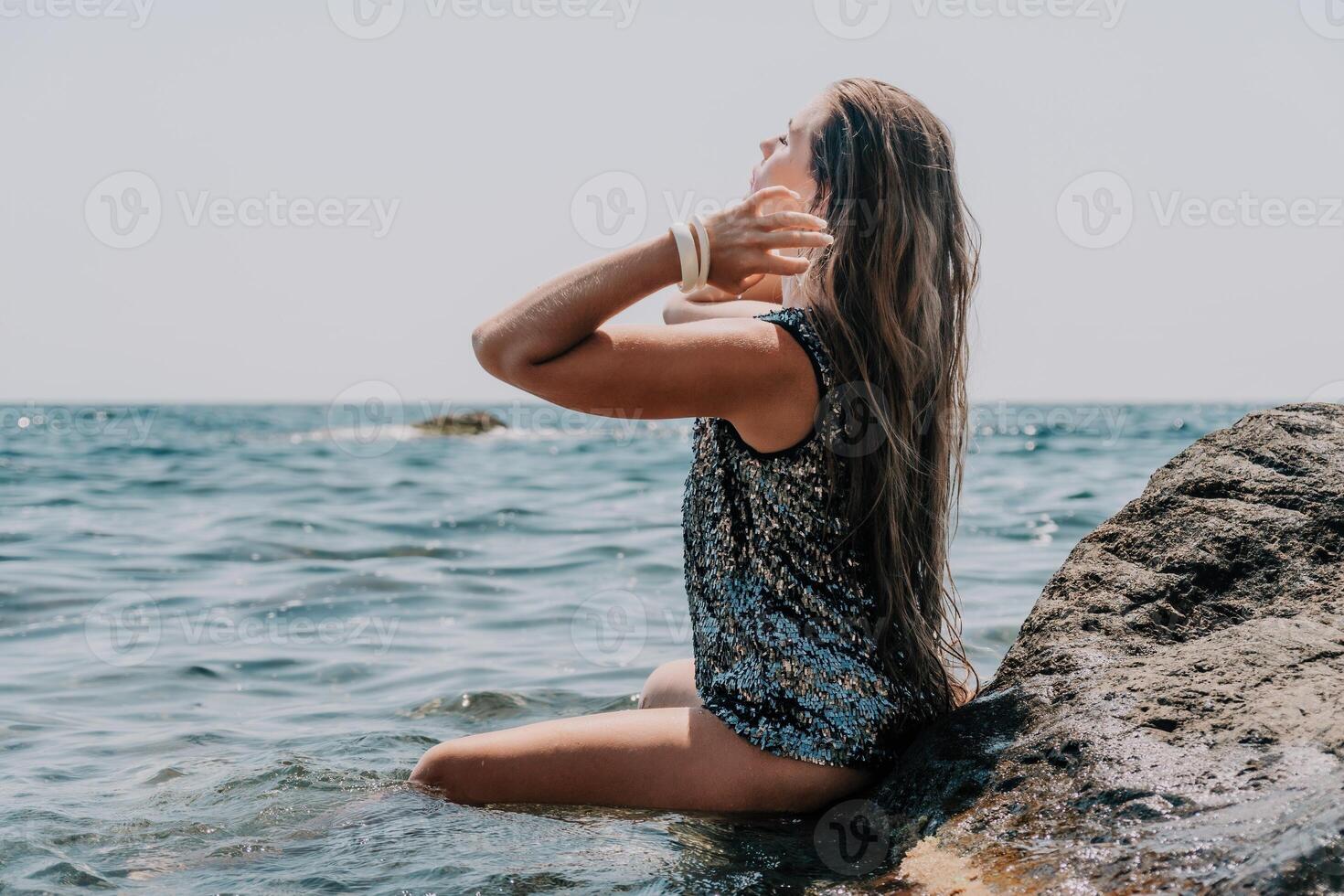 Woman summer travel sea. Happy tourist enjoy taking picture outdoors for memories. Woman traveler posing on the beach at sea surrounded by volcanic mountains, sharing travel adventure journey photo