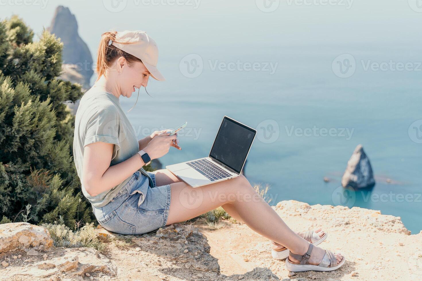 Woman sea laptop. Business woman, freelancer with laptop working over blue sea beach. Happy smiling girl relieves stress from work. Freelance, remote work on vacation, digital nomad, travel concept photo