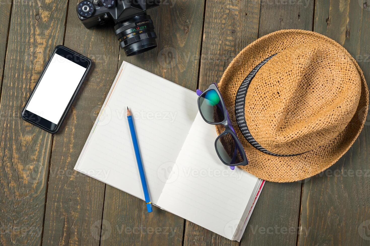 Mock up of summer traveling stuff on wooden board photo