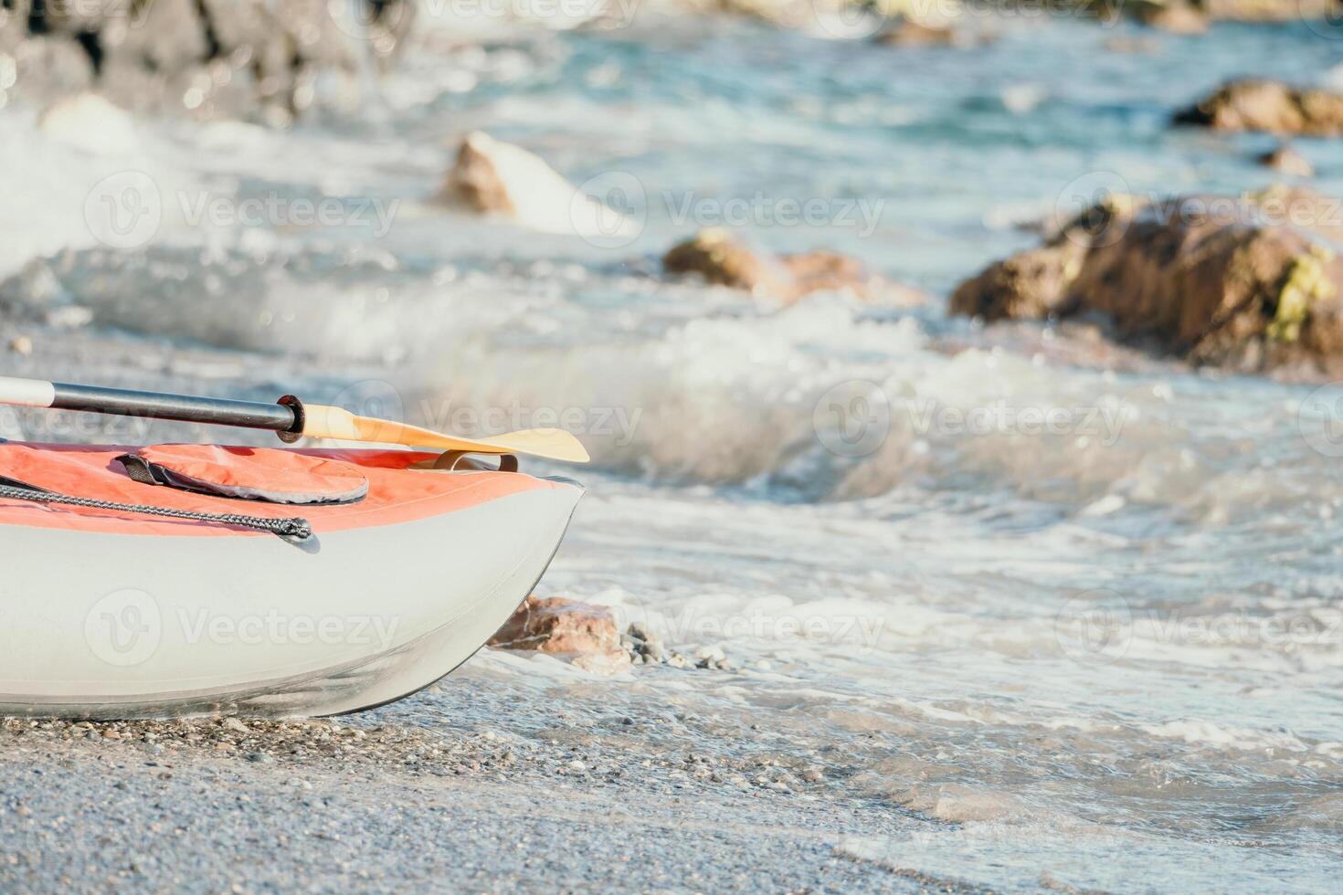 Happy couple kayaks in an inflatable kayak on the sea at sunset. Couple kanoeing in the sea near the island with mountains. People kayaking in life jackets sail. Back view photo