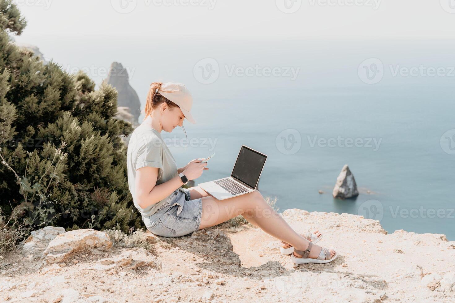 Woman sea laptop. Business woman, freelancer with laptop working over blue sea beach. Happy smiling girl relieves stress from work. Freelance, remote work on vacation, digital nomad, travel concept photo