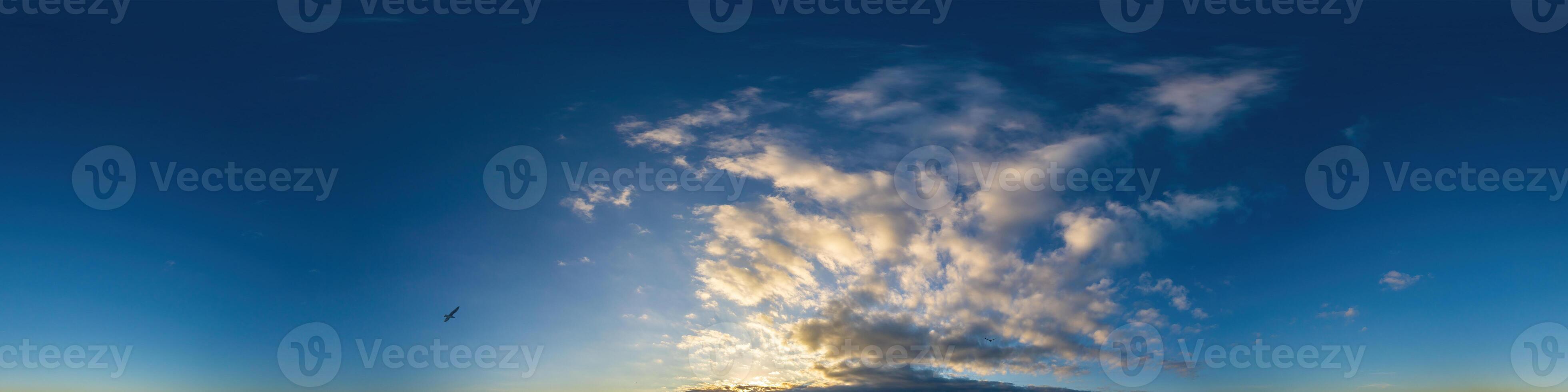 Dark blue sunset sky panorama with Cumulus clouds. Seamless hdr pano in spherical equirectangular format. Complete zenith for 3D visualization, game and sky replacement for aerial drone 360 panoramas. photo