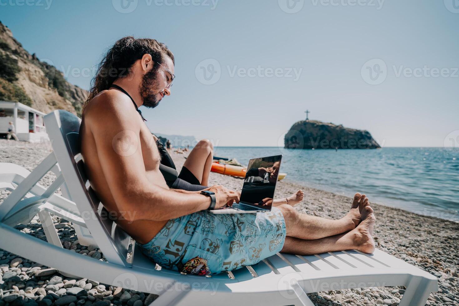 Man woman laptop sea. Working remotely on seashore. Happy successful couple, freelancers working on sea beach, relieves stress from work to restore life balance. Freelance, remote work on vacation photo