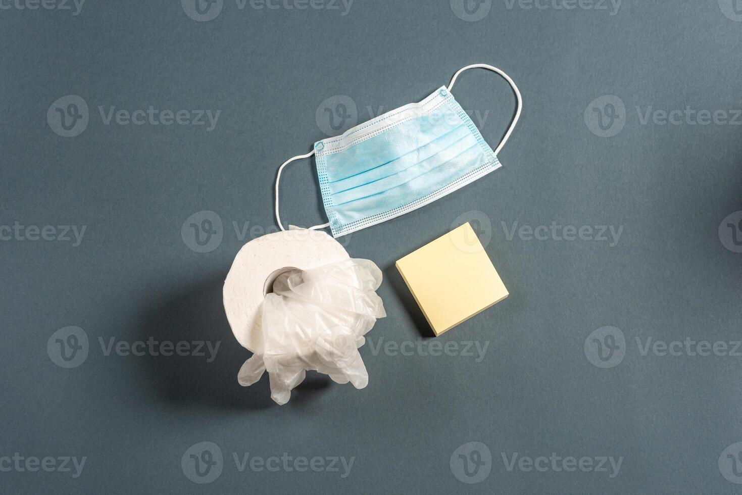 Top view of grey color office table with calendar and surgical face mask. photo