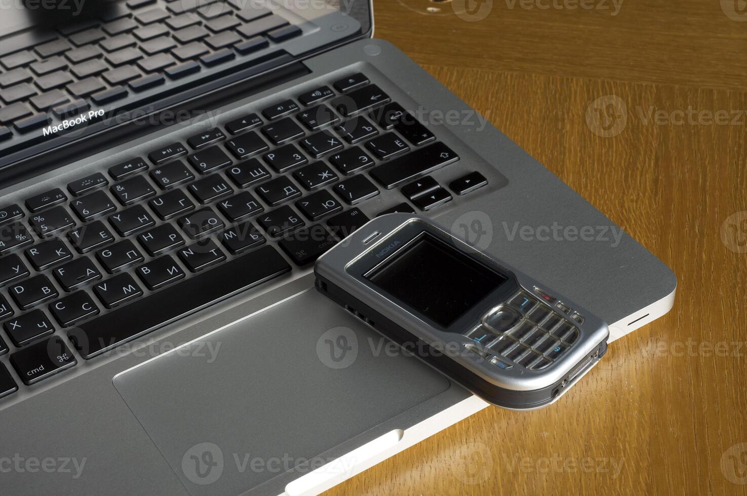 Phone, laptop and empty notebook on the desk photo
