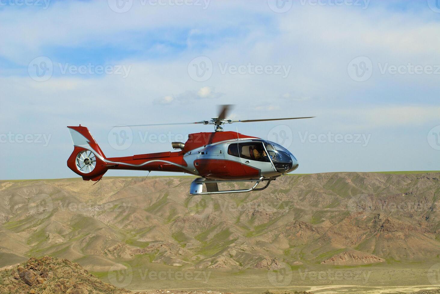 Helicopter flying over the river photo