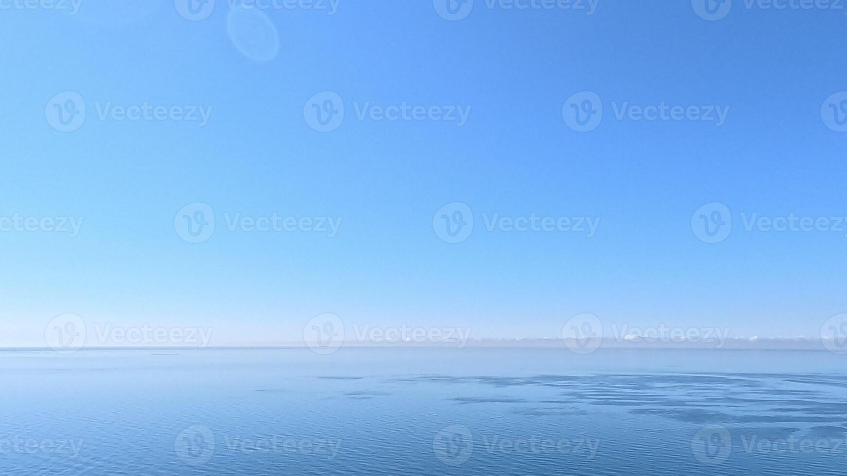 Aerial view on calm azure sea and volcanic rocky shores. Small waves on water surface in motion blur. Nature summer ocean sea beach background. Nobody. Holiday, vacation and travel concept photo