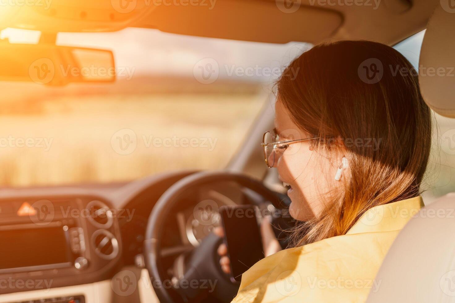 Happy woman talking on the phone while sitting in the car on nature Relaxed call, professional conversation, female executive in automobile. business woman talking on call on phone. photo