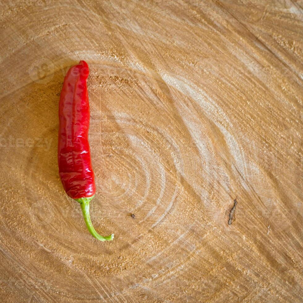 Red chilli pepper on a wooden background photo