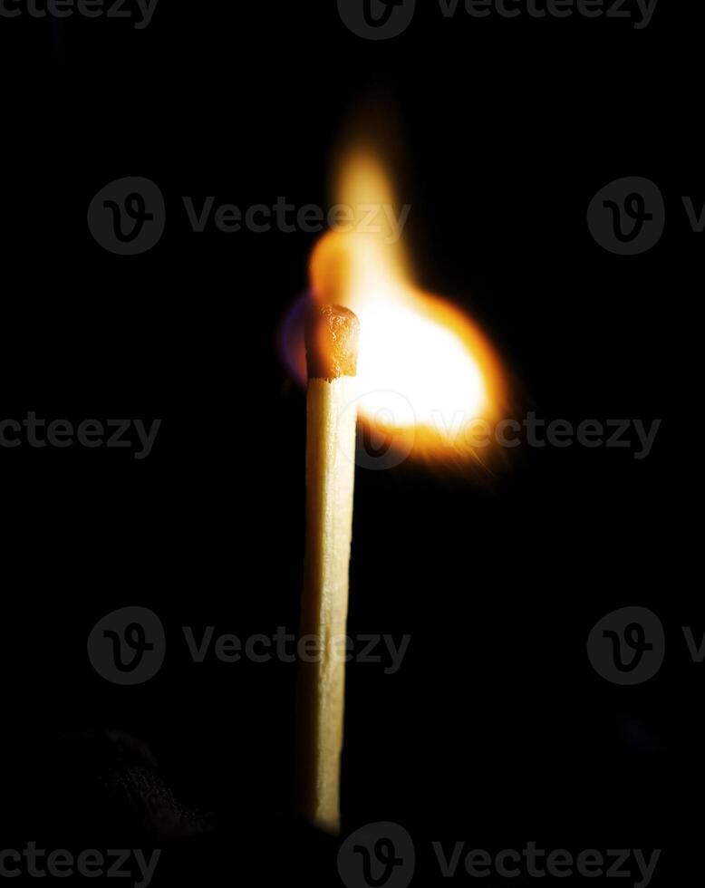 Wooden match burning on a black background photo