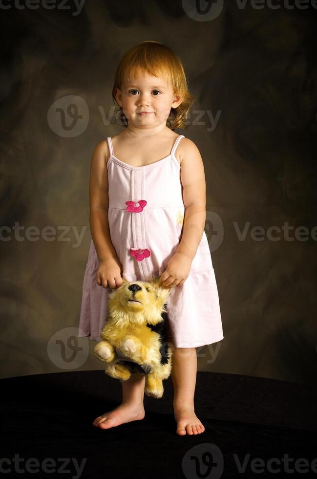 Girl plays with the toy dog photo