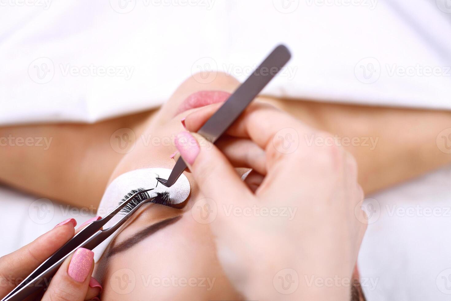 Eyelash Extension Procedure. Woman Eye with Long Eyelashes. Lashes, close up, macro, selective focus. photo