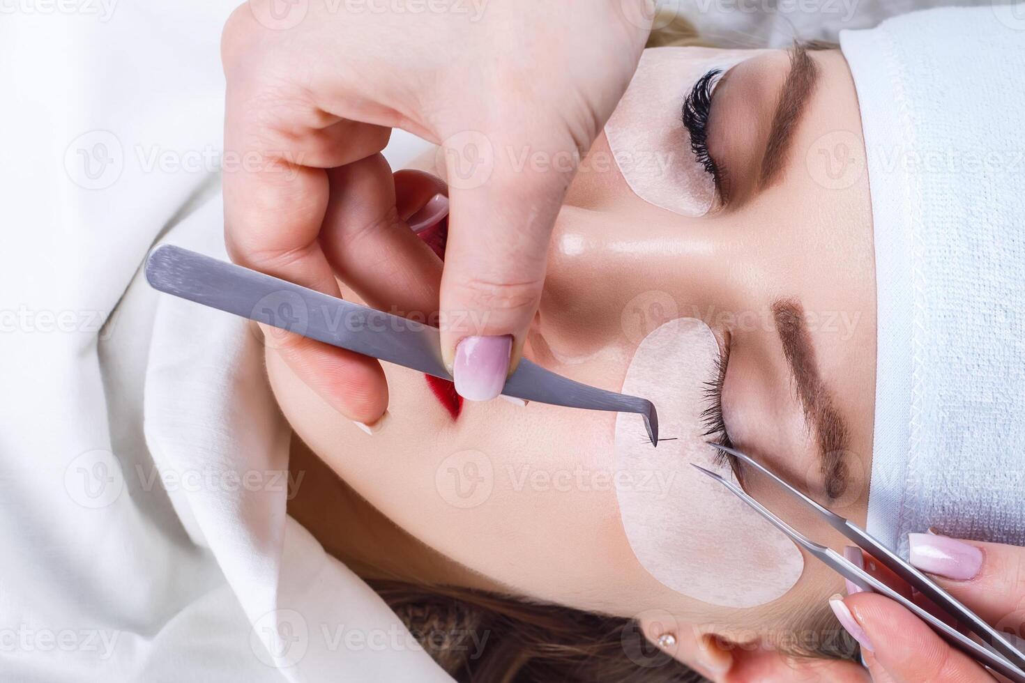 Eyelash Extension Procedure. Woman Eye with Long Eyelashes. Lashes, close up, selected focus. photo