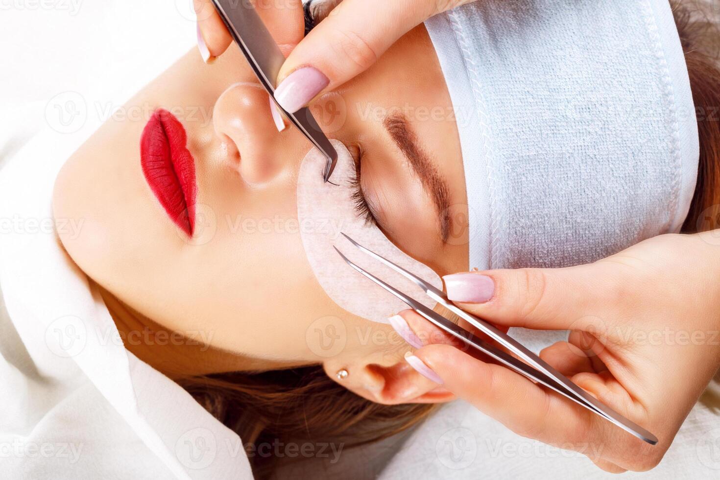 Eyelash Extension Procedure. Woman Eye with Long Eyelashes. Lashes, close up, selected focus. photo