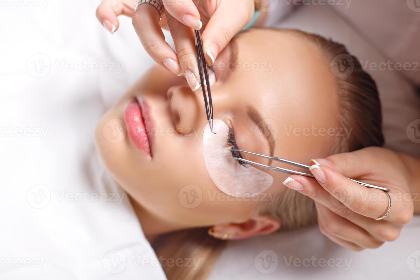Eyelash Extension Procedure. Woman Eye with Long Eyelashes. Lashes, close up, selected focus. photo