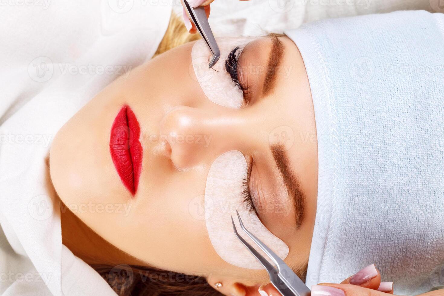 Eyelash Extension Procedure. Woman Eye with Long Eyelashes. Lashes, close up, selected focus. photo