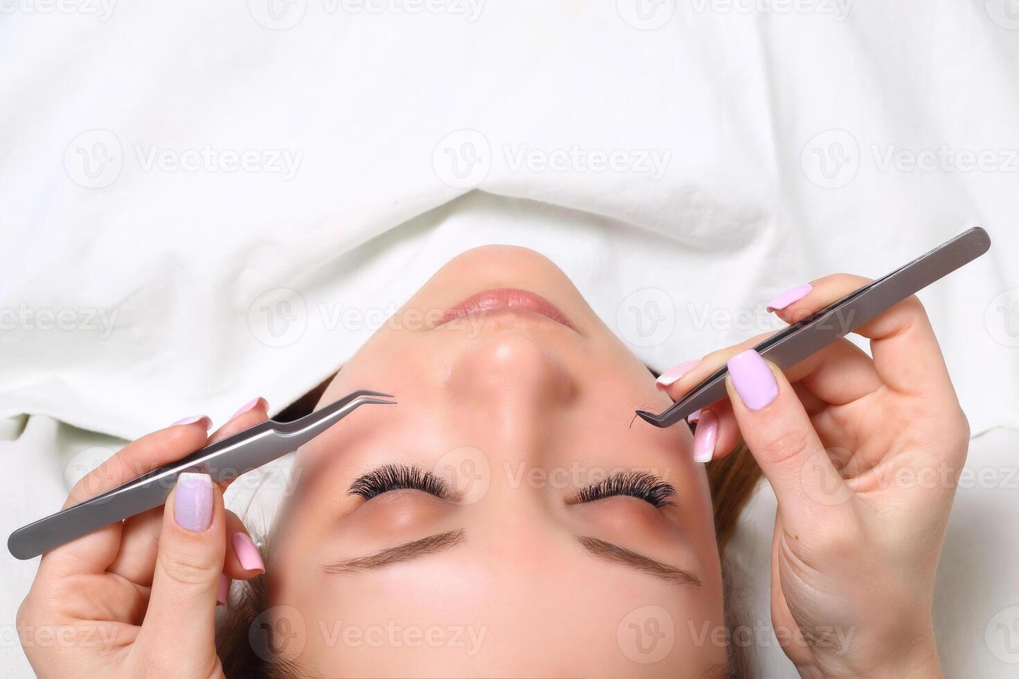 Eyelash Extension Procedure. Woman Eye with Long Eyelashes. Lashes, close up, selectve focus. photo