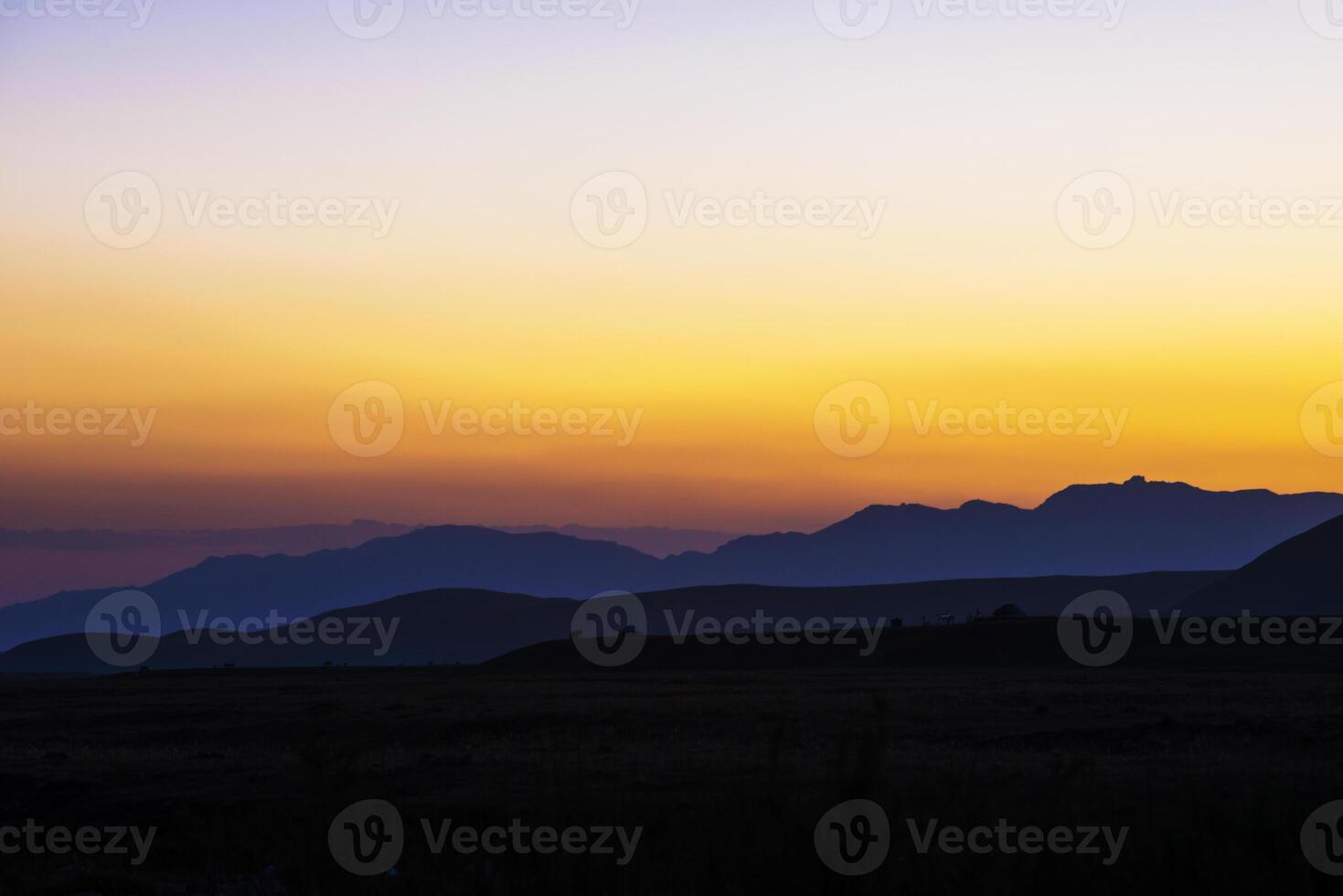 view of a valley in a beautiful early night with fog between hills photo