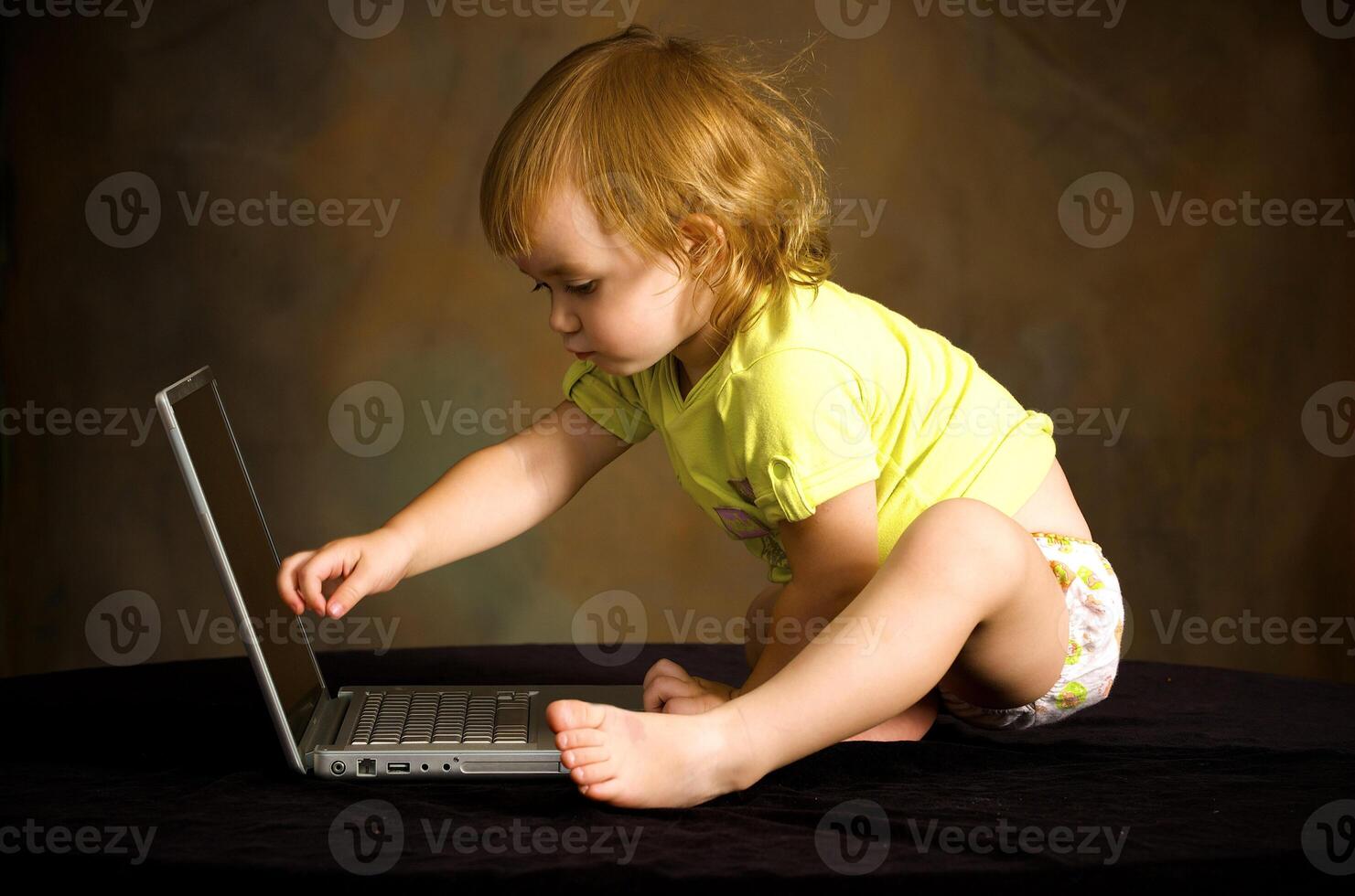 Small girl works with the computer photo
