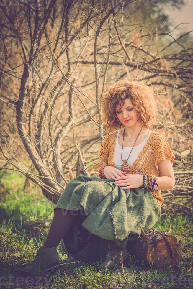 Fashion shot of a beautiful boho style girl on nature background. Boho, hippie. photo