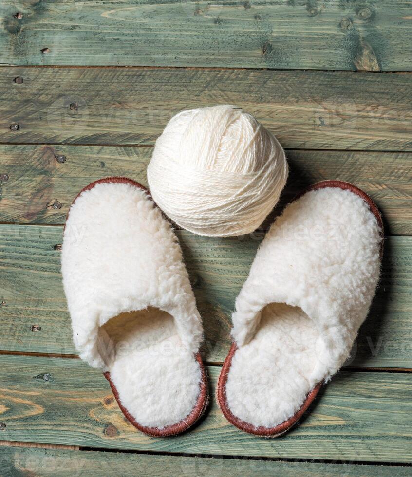 White slippers on the wooden background. Beauty and fashion. photo