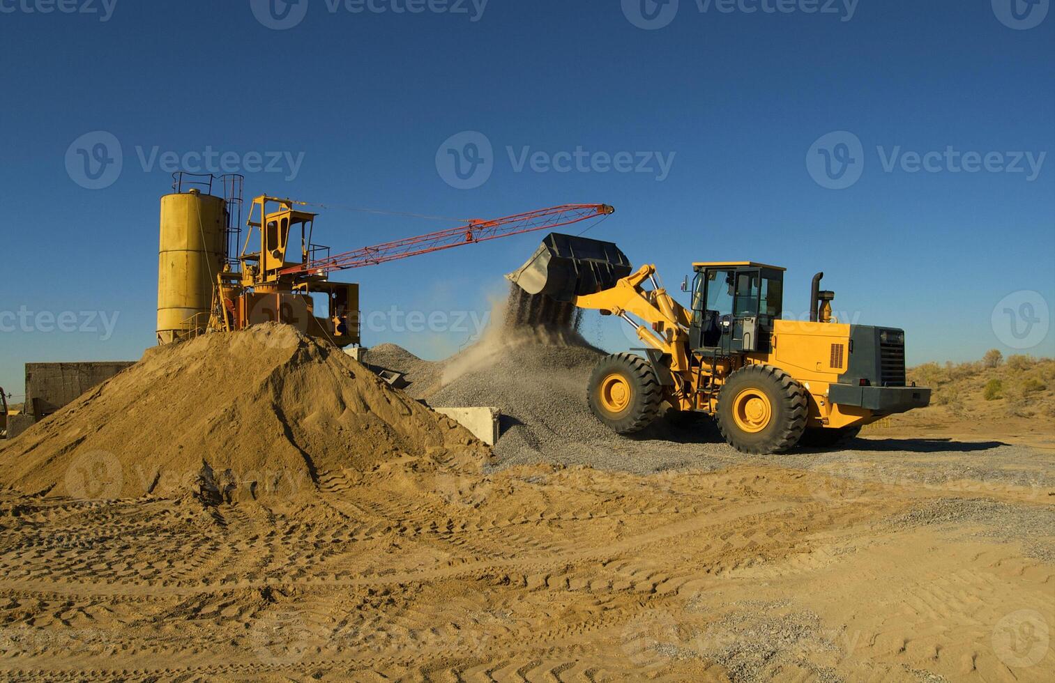 Bulldozer loads crushed stone into the scoop photo