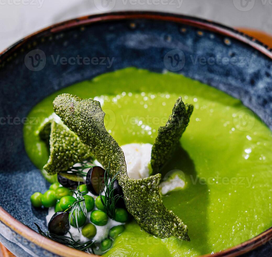 peas, broccoli, spinach cream soup in a bowl photo