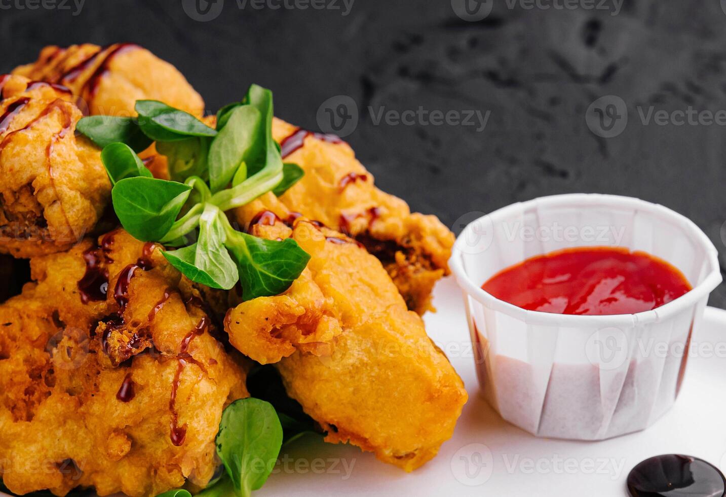 Traditional battered fried fish on plate photo