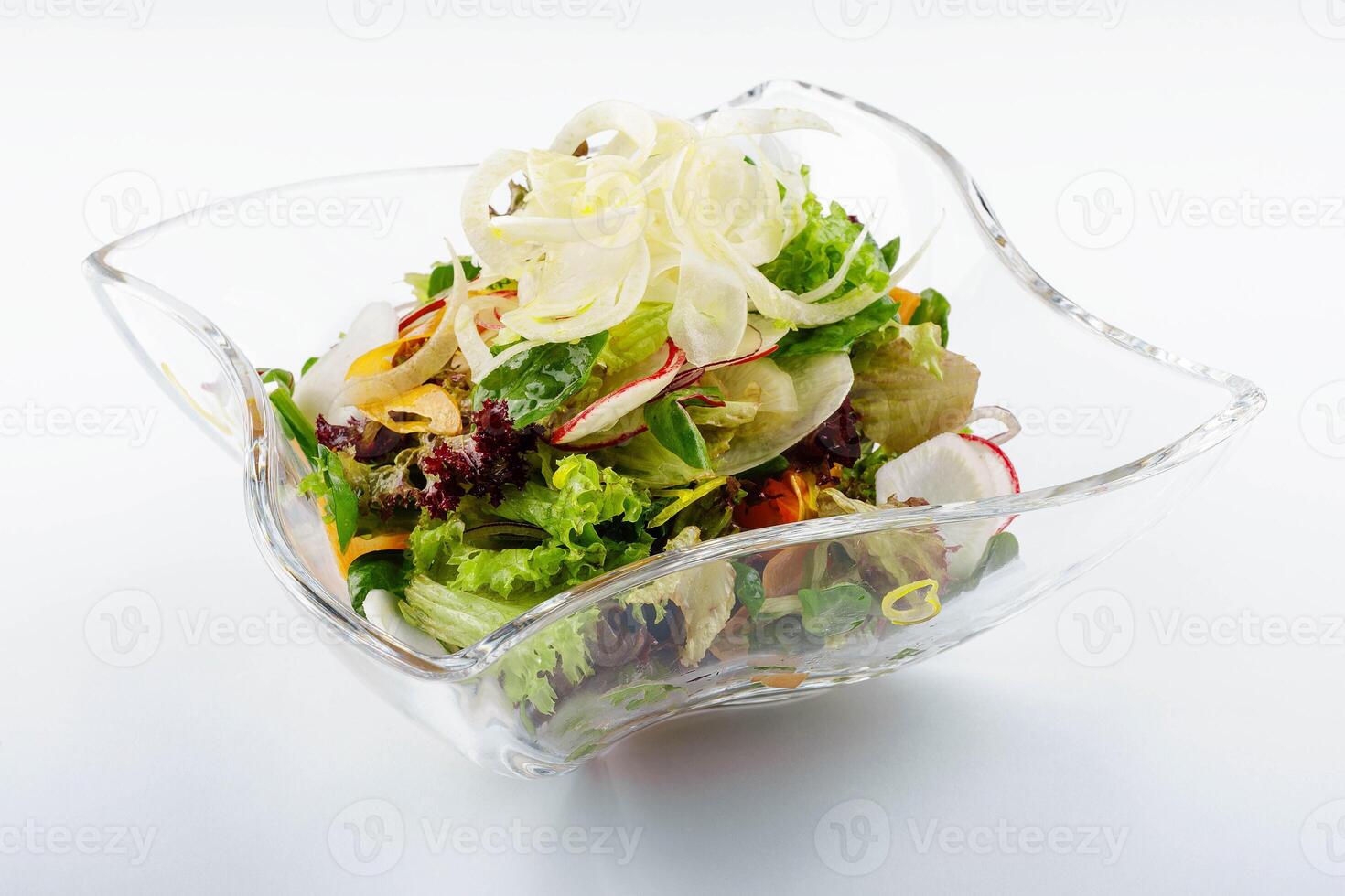 Radish salad in glass bowl isolated on white photo