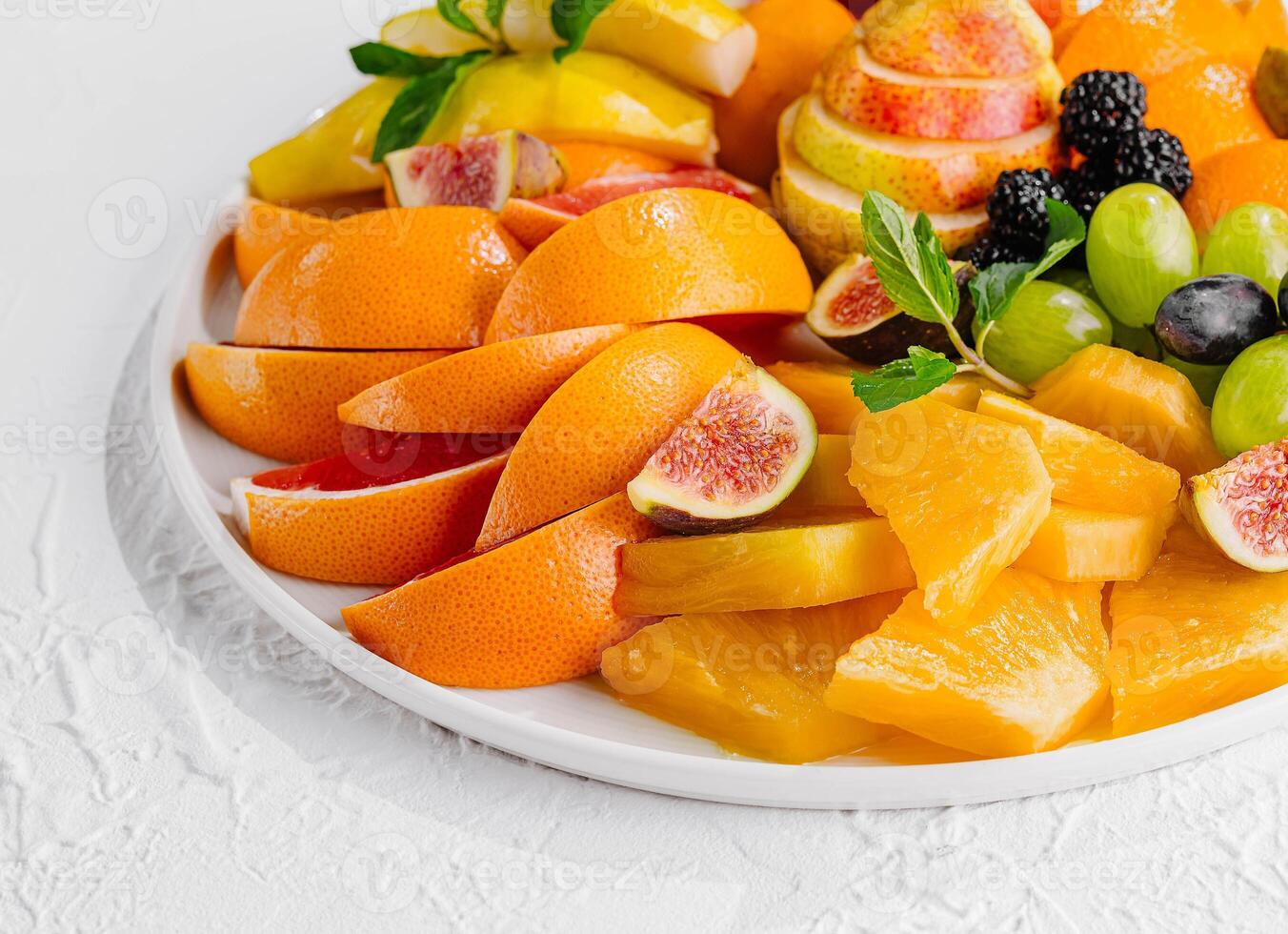 Exotic fruits platter isolated on white photo