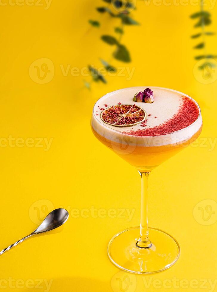 tropical cocktail on yellow background top view photo