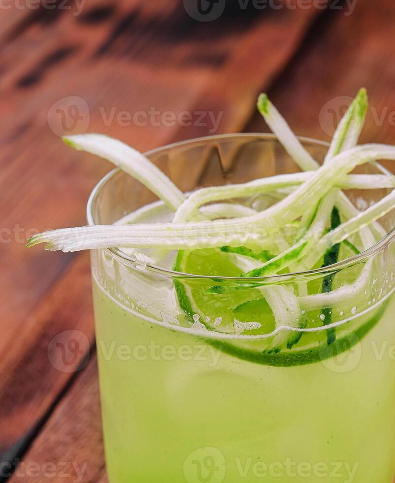 Glass of fresh mojito on wooden table photo