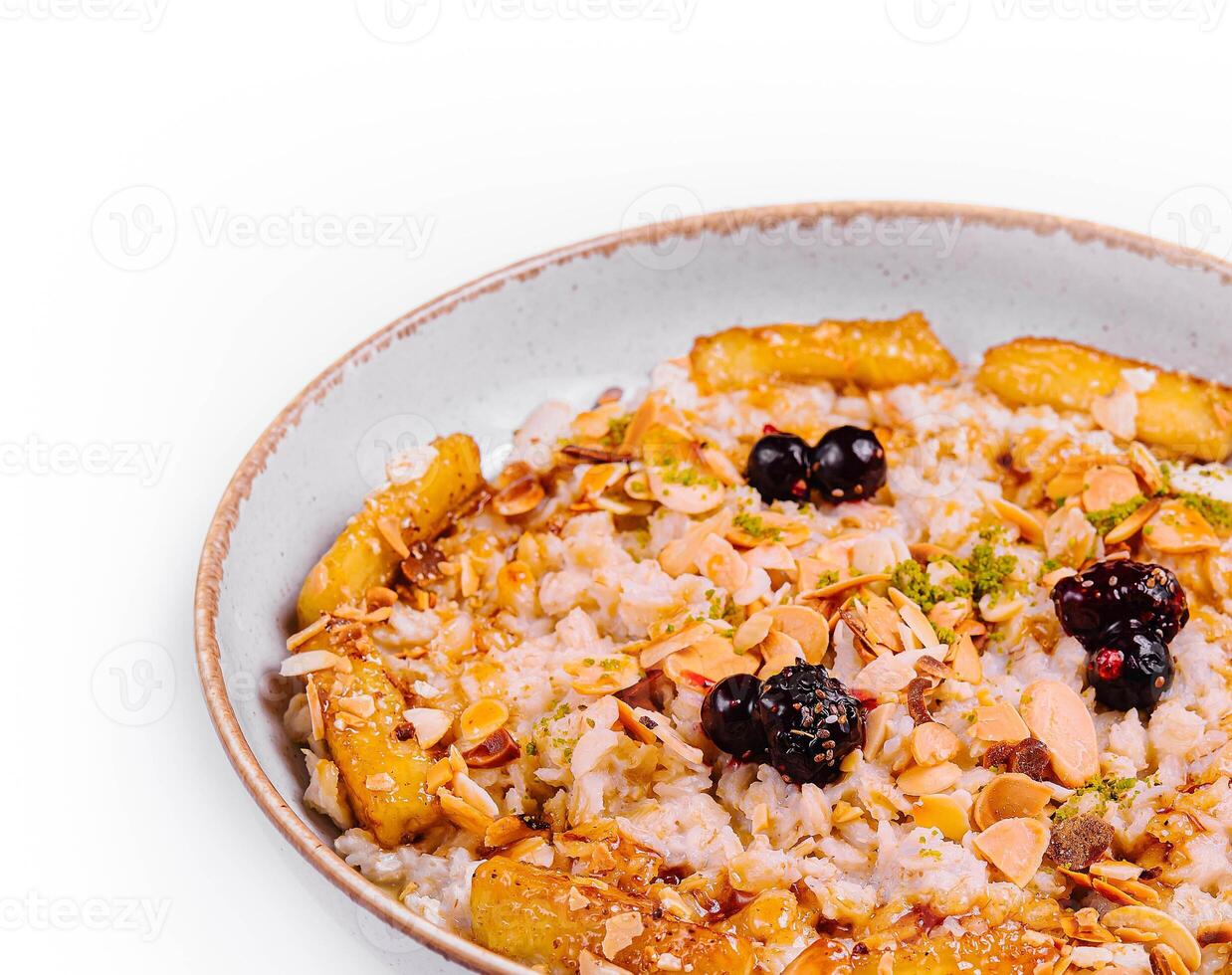 Muesli with dried fruits and milk in ceramic bowl photo