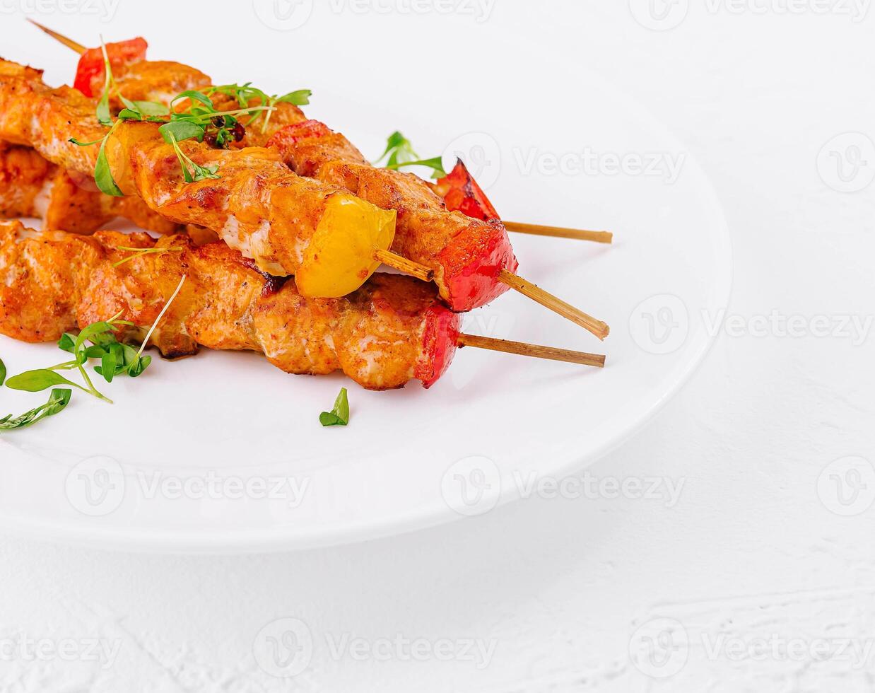 Chicken skewers with slices of sweet peppers photo